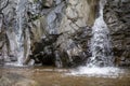 Choose the focus rock beside the waterfall The waterfall\'s walls look moist all the time. A small stream waterfall