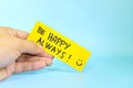 Choose happiness and be happy always reminder concept. Hand holding a bright yellow paper message