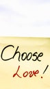 Choose love handwriting text close up isolated on yellow paper with copy space