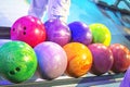 choose multi-colored balls according to their heaviness for the game of bowling.