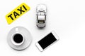 Choose a taxi in mobile application. Taxi label, cell phone, car toy on white background top view copyspace Royalty Free Stock Photo