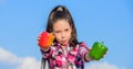 Choose which. Alternative decision concept. Kid girl hold red and green peppers sky background. Kid hold ripe pepper