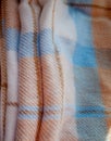 Winter woolen plaid in brown stripes of blue and white