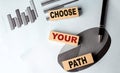 CHOOSE YOUR PATH text on wooden block on chart background Royalty Free Stock Photo