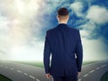 Choose your way. Man standing at crossroads taking important decision Royalty Free Stock Photo