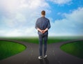 Choose your way. Man standing at crossroads taking important decision Royalty Free Stock Photo