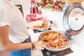 Choosing food in open buffet at breakfast in hotel