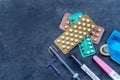 Choosing method of contraception : Birth control pills, an injection syringe, condom, IUD-method, on grey