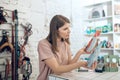 Dark-haired girl choosing nutriments for her pet in a pet store Royalty Free Stock Photo