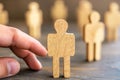 choosing standout wooden figure among crowd of potential job candidates