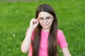 Choosing trendy accessories. Little girl wear glasses green grass. Fashion accessories. Designer eyewear and accessories