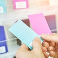 Choosing wall color sample. Man hands holding paper example. Blue or pink choice Royalty Free Stock Photo