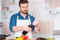 Choosing the wine bottle during food preparation Royalty Free Stock Photo