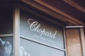 Chopard Swiss brend sign on city street. Signboard logo of Chopard Swiss manufacturer of luxury jewellery and watches store, shop