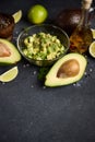 Chopped avocado in glass bowl and avocado Halves