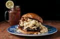 Chopped Brisket Mac and Cheese sandwich with bbq sauce on rustic Royalty Free Stock Photo