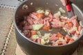 chopped cababresa sausage with onion in an aluminum pot Royalty Free Stock Photo