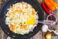 Chopped cabbage with carrots in frying pan