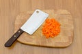 Chopped carrot and chopping knife on chopping block