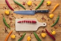 Chopped cayenne chilli pepper on cutting board with knife and other peppers all around Royalty Free Stock Photo