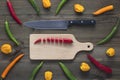 Chopped cayenne chilli pepper on cutting board with knife Royalty Free Stock Photo