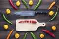 Chopped cayenne chilli pepper on cutting board with knife Royalty Free Stock Photo