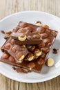 Chopped chocolate with nuts on a white plate