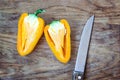 Chopped cut colorful vibrant bright yellow fresh ripe sweet pepper on old cutting wooden board table background