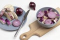 Chopped eggplant and chopped violet onions in bowl and on cutting board Royalty Free Stock Photo