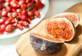 Chopped Fig fruits on the cutting board with briar (dog rose) on Royalty Free Stock Photo