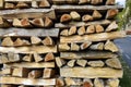 Chopped firewood is stacked in neat piles near highway. Trade in chopped firewood. Preparing firewood for winter. Woodpile. Royalty Free Stock Photo