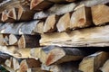 Chopped firewood is stacked in neat piles. Woodpile. Background. Close-up. Royalty Free Stock Photo