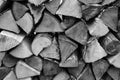 Chopped firewood is stacked in neat piles. Woodpile. Full frame, background. Close-up. Black and white photo. Royalty Free Stock Photo