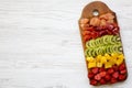 Chopped fresh fruits arranged on cutting board on white wooden background with copy space, top view. Ingredients for fruit salad. Royalty Free Stock Photo