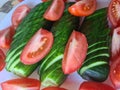 Chopped fresh pickled cucumbers and tomatoes on plates