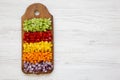 Chopped fresh vegetables arranged on cutting board on white wooden table, overhead view. Flat lay, from above, top view. Blank spa Royalty Free Stock Photo