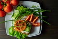 Chopped fresh vegetables decorated with spicy greens