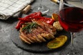 Chopped fried pork steak, vegetables and wine on background. Grilled food Royalty Free Stock Photo