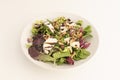 chopped goat cheese salad, assorted lettuce sprouts, peeled and split California walnuts, balsamic vinegar