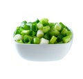 Chopped green onion in a ceramic bowl isolated on white background Royalty Free Stock Photo