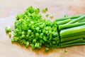Chopped green onions on an old wooden chopping board Royalty Free Stock Photo