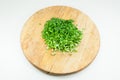 Chopped green onions on a wooden chopping board Royalty Free Stock Photo