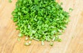 Chopped green onions on a wooden chopping board Royalty Free Stock Photo