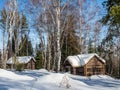 Chopped log house of lumberjacks and builders covered with snow in a winter forest in Altai, Russia Royalty Free Stock Photo