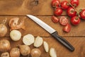 Chopped onions and tomatoes, knife on wood