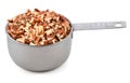Chopped pecan nuts in a metal cup measure Royalty Free Stock Photo