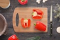 Chopped peppers on the cutting board on kitchen table Royalty Free Stock Photo