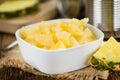 Chopped Pineapple preserved on wooden background; selective fo