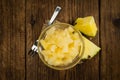 Chopped Pineapple preserved on wooden background; selective fo