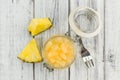 Chopped Pineapple preserved on wooden background; selective fo